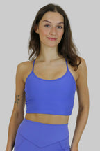 Woman wearing a blue athletic outfit on a plain background